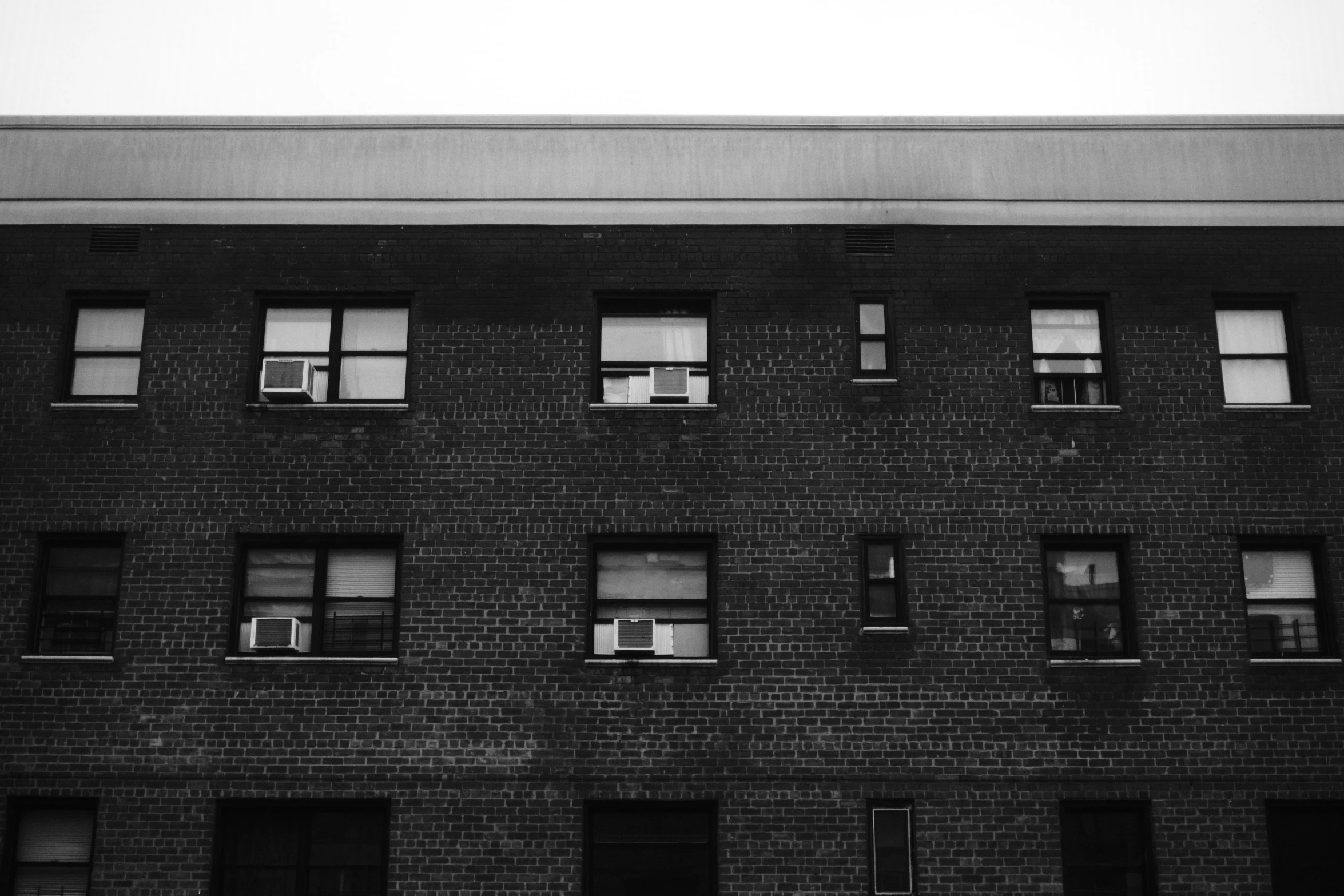 an airplane flying over a tall black building