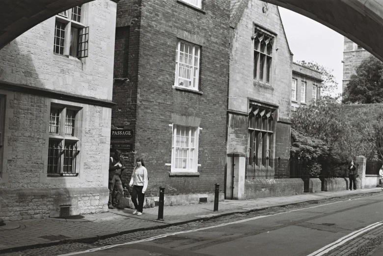 black and white pograph of two people on a city street