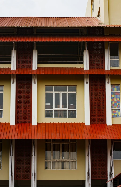 a close up of an orange tiled roof and windows