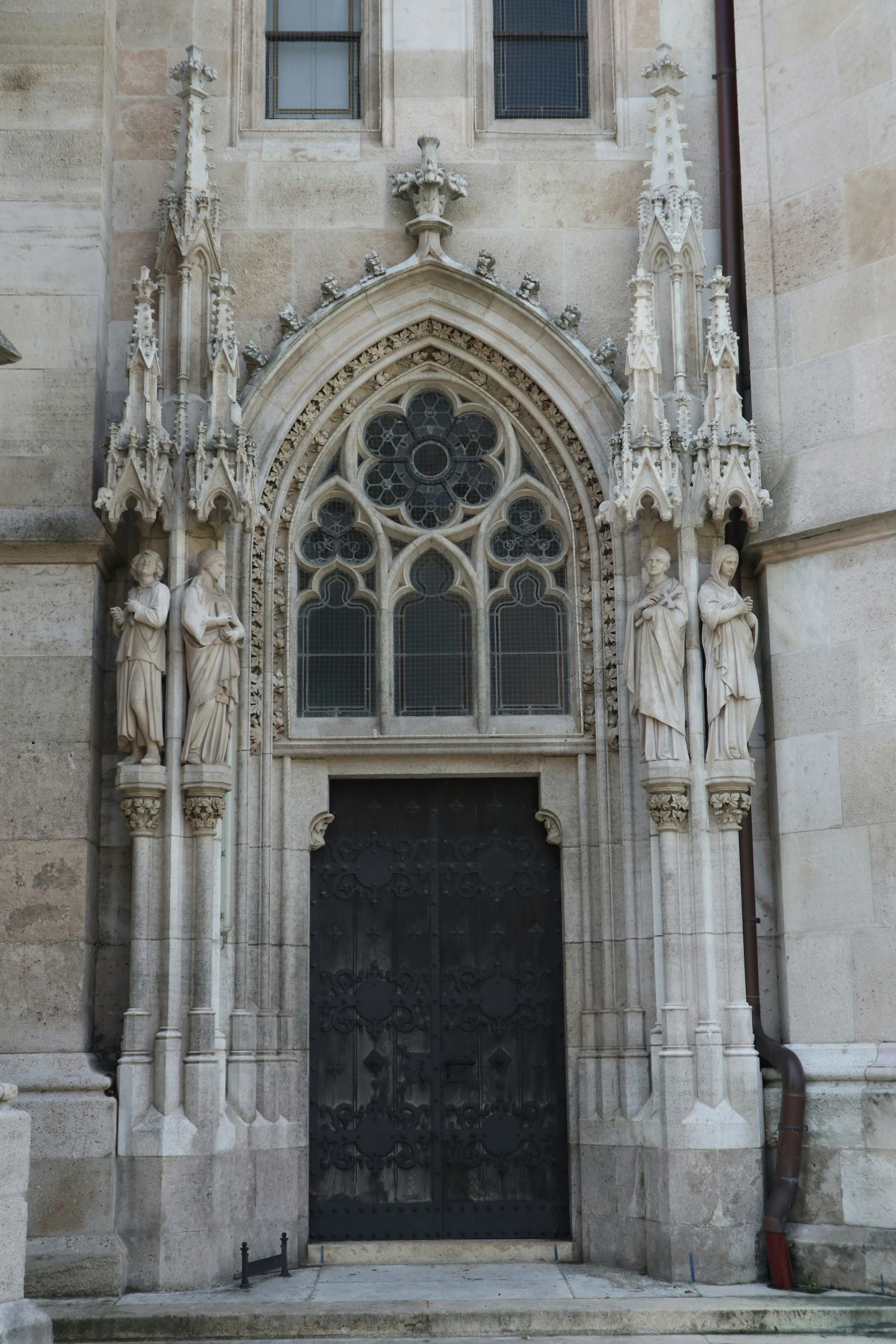 a very big fancy door on the side of a tall building