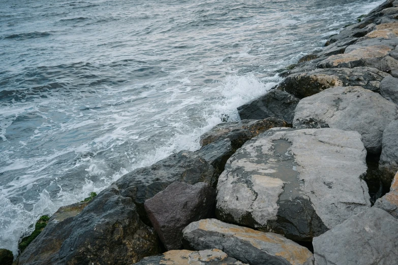 a view of water and rocks on a rocky beach