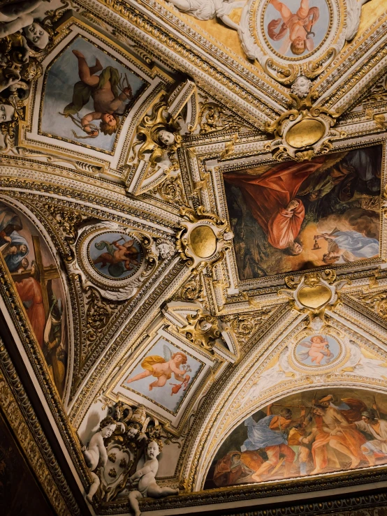 the ceiling of a building has various paintings on it