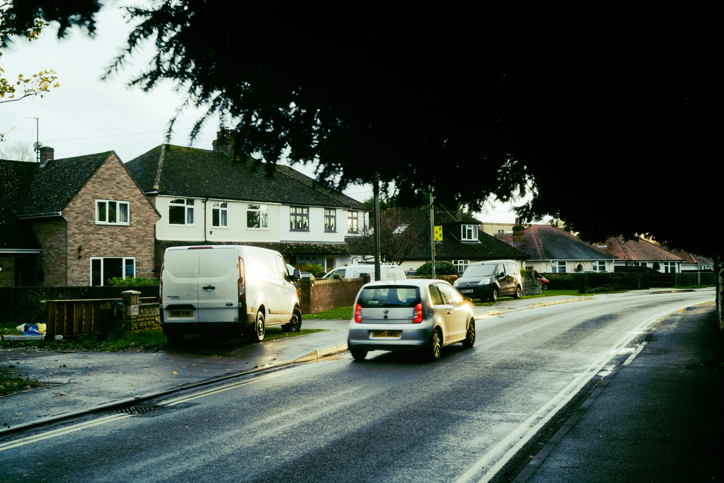 cars parked on a side walk along the city street