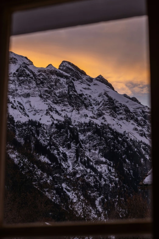 a mountain in the distance from inside a window