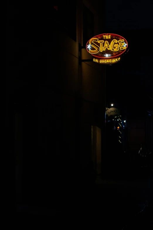 the sign for the street side bar lit up at night