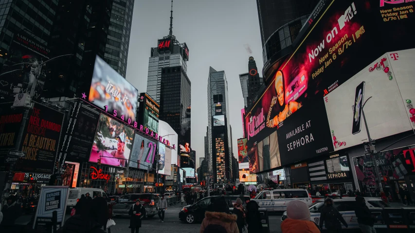 the view of a city street that has multiple billboards all over it