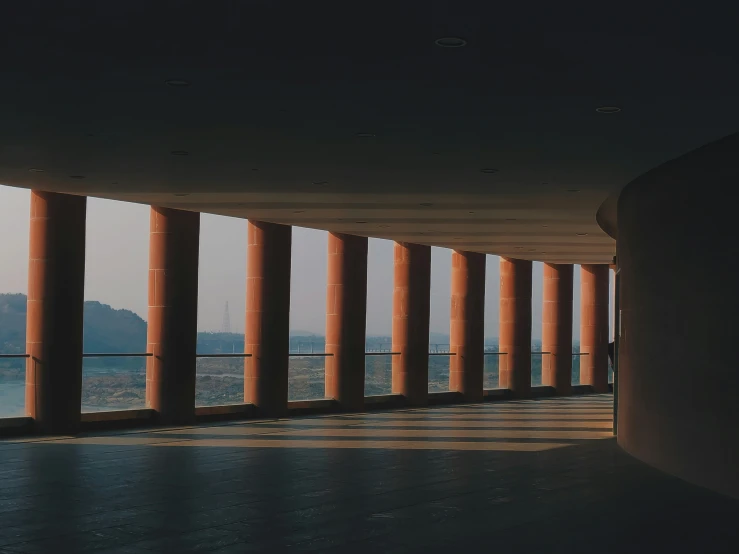 a view of the sea from a large room with columns