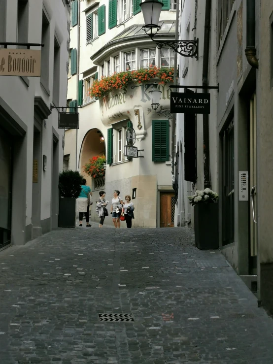 a woman with a purse is walking down an alleyway