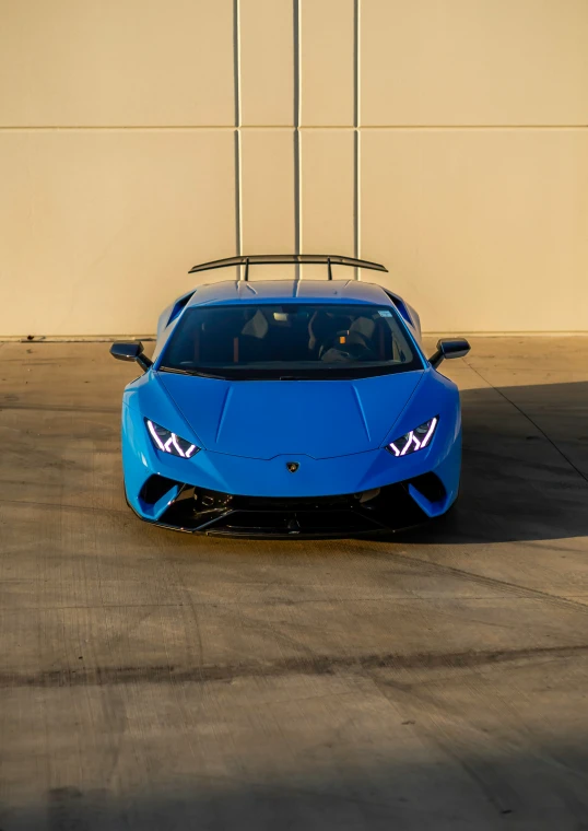 a blue lamb svrvo parked in front of a building