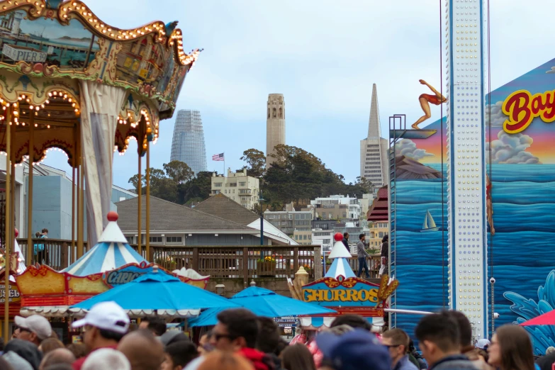 an ocean themed carnival with large rides and people walking