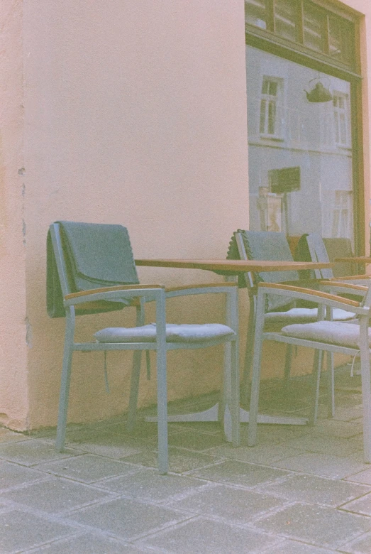 two chairs are sitting outside of the door of a building