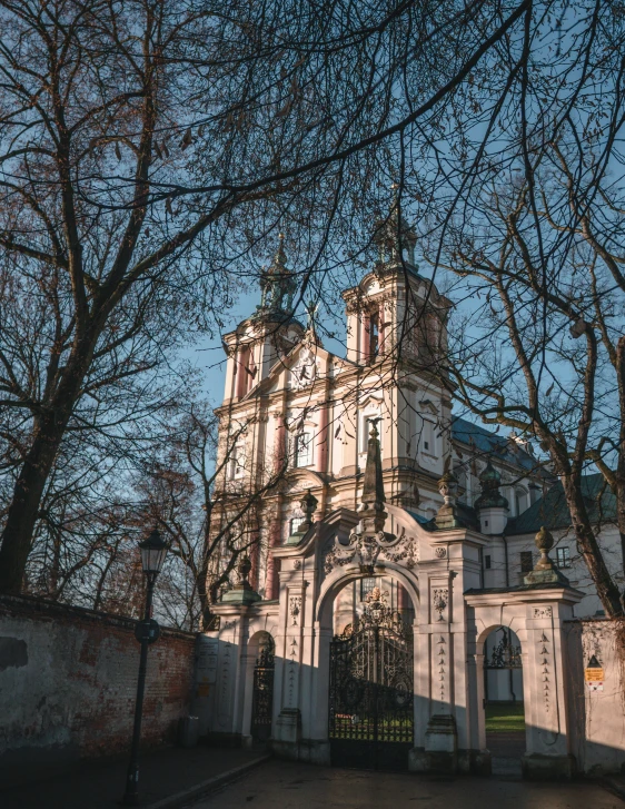 a white building with turrets and towers sitting next to a tree