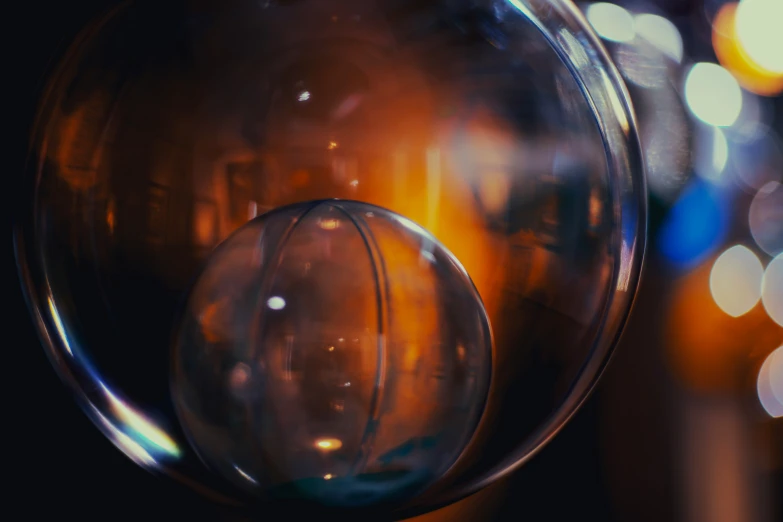 a round glass object is hanging in front of some lights