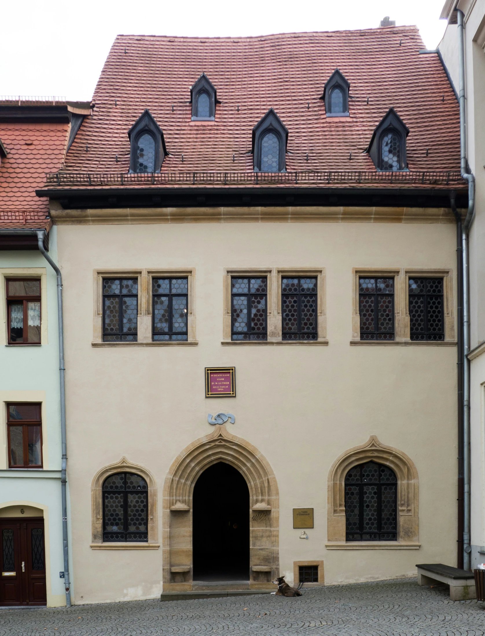 large building with arches and arched windows near courtyard