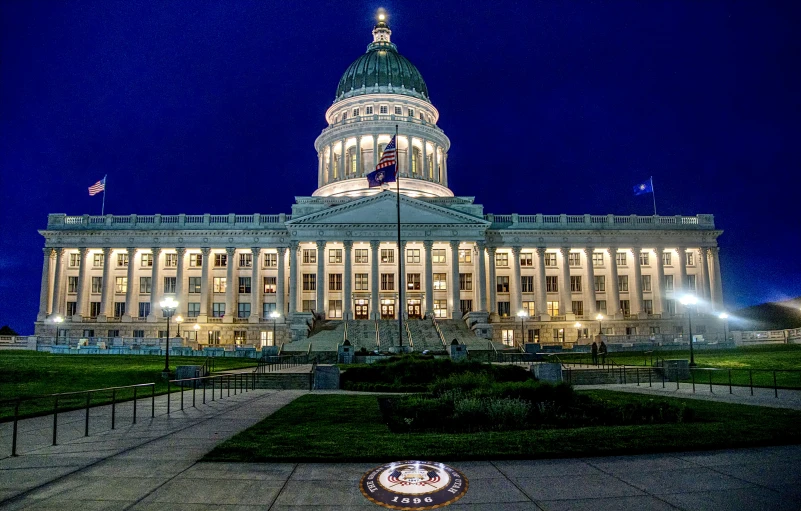 a large white building with a circular fountain in the center of it