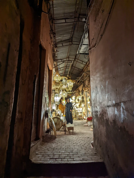 an alley with a man and several things on it