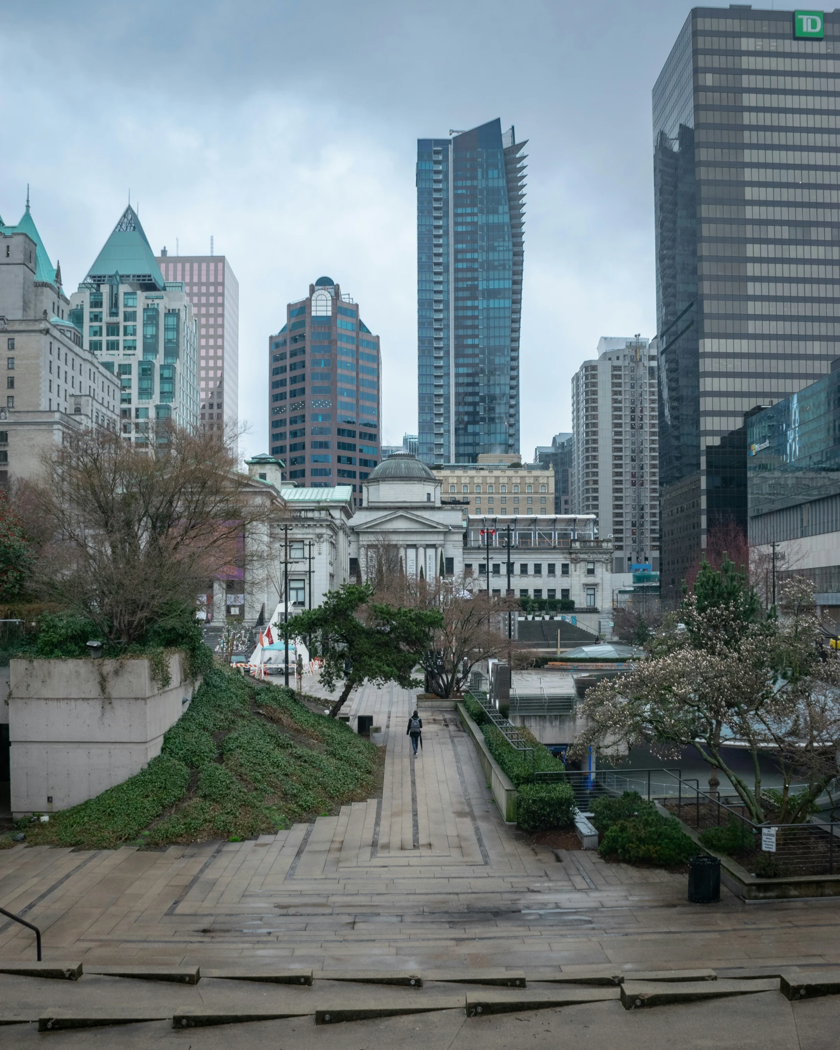 a large empty path that is beside some tall buildings