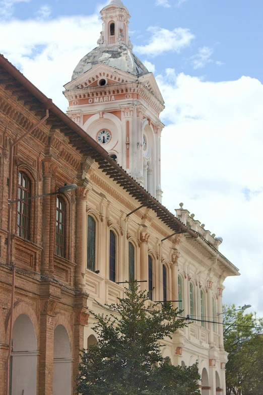 an old building with a clock tower and an attached street lamp