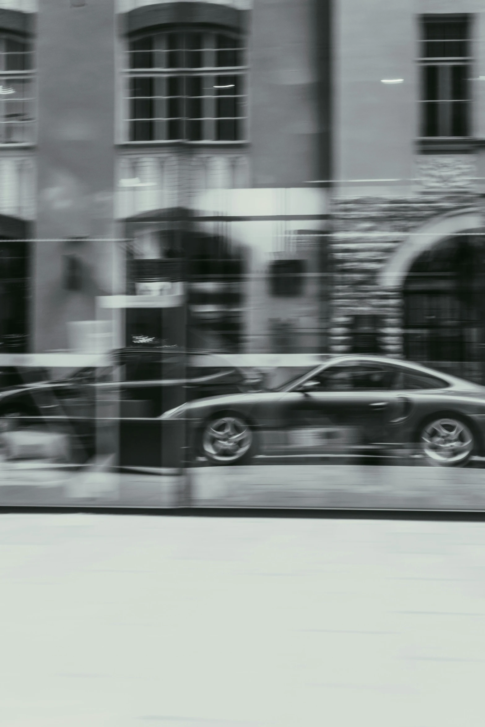 a car with its doors open driving past a building