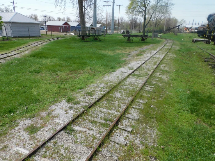 a dirt track going through the middle of a field