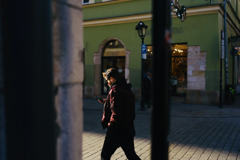 a man walking down the street at night