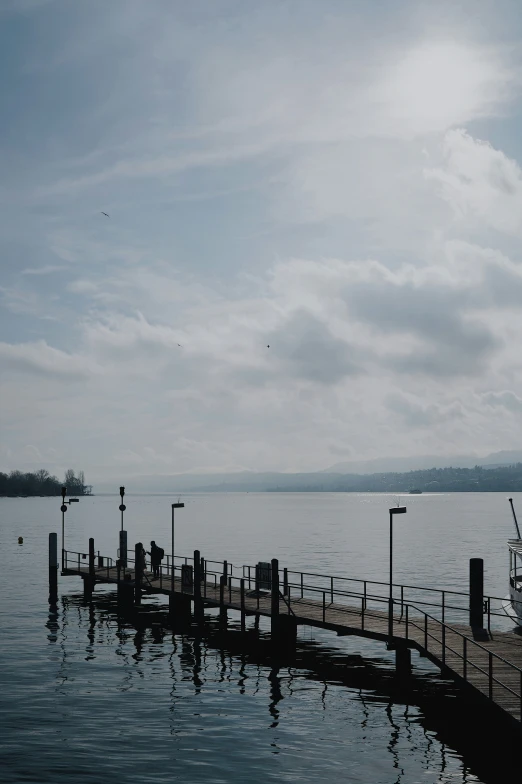 a dock on the water that has multiple poles connected to it