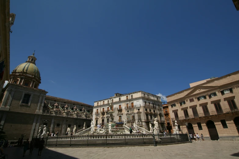 the old town square in europe has a church, fountain, and statues on it