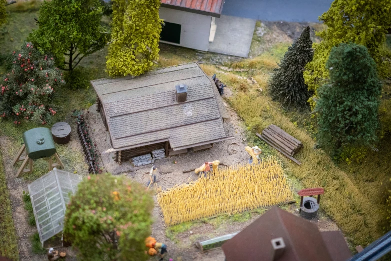 a miniature farm scene with an old fashioned shed