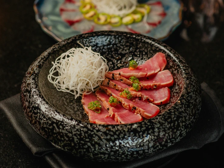 two plates that have food on them, one with ramen noodles