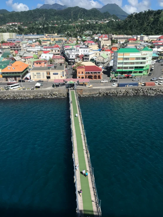 a dock extends into the ocean and leads down into the town