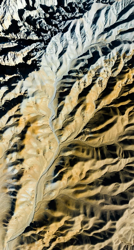 an aerial view of a beach, ocean and mountains