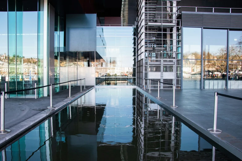 a large outdoor water pool next to a tall building