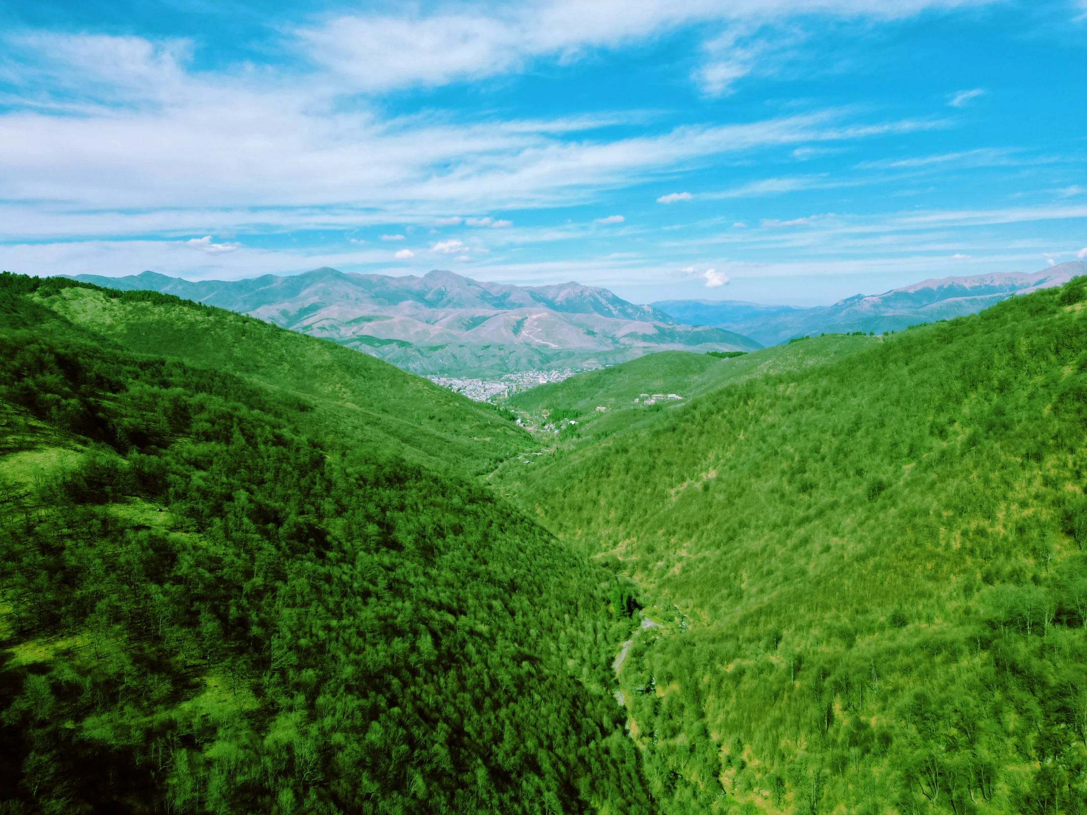 this view shows a valley and the surrounding mountains