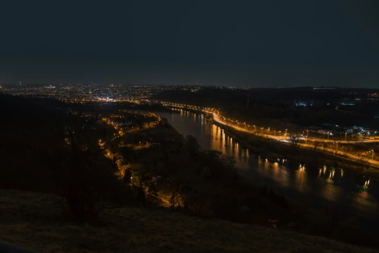 a night time view of a city that looks like it is over the water