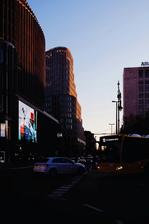 a bus drives along a city street in the evening