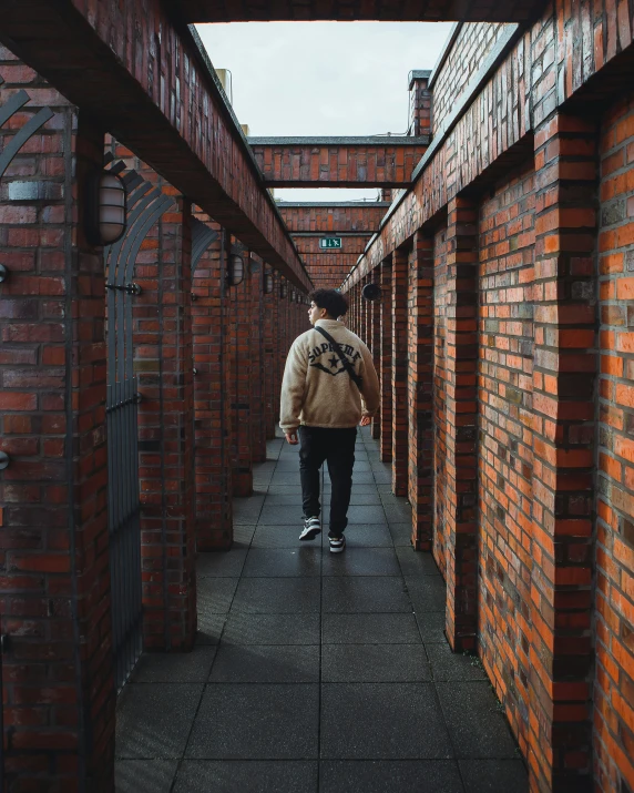 the person with a backpack is walking down the street