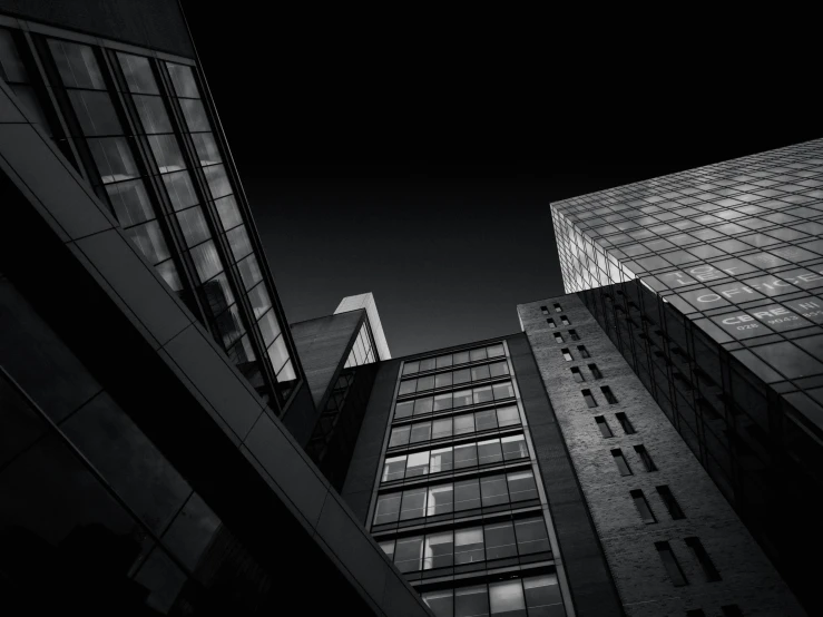 three tall building are lit up at night