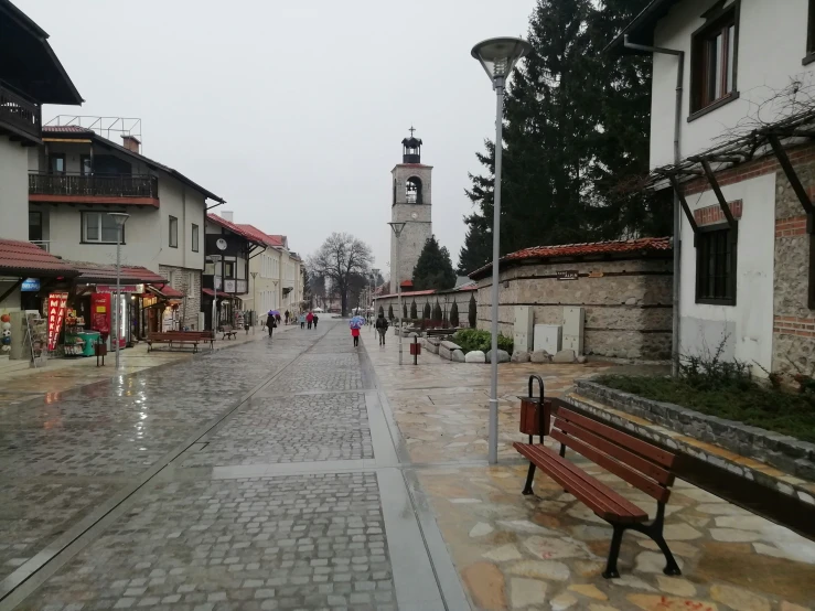 a street with people walking on the sidewalk