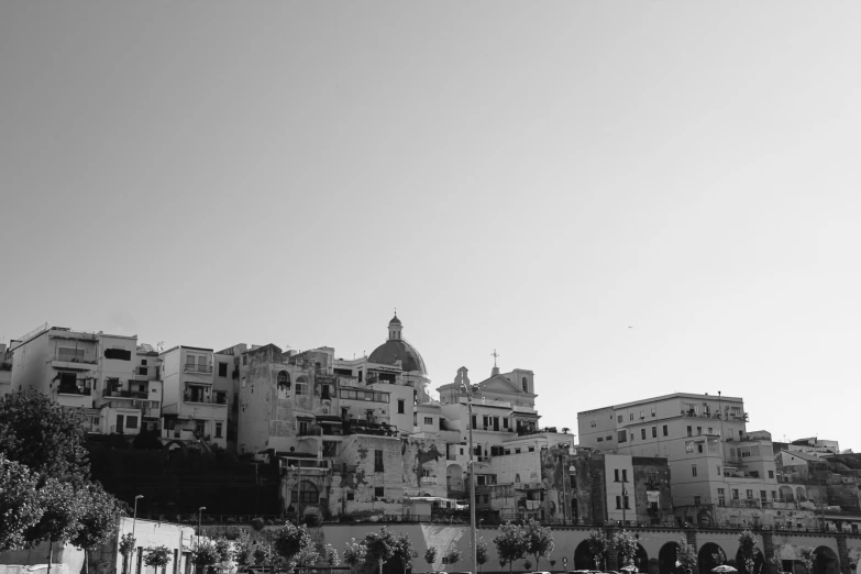 a black and white pograph of a hill side city