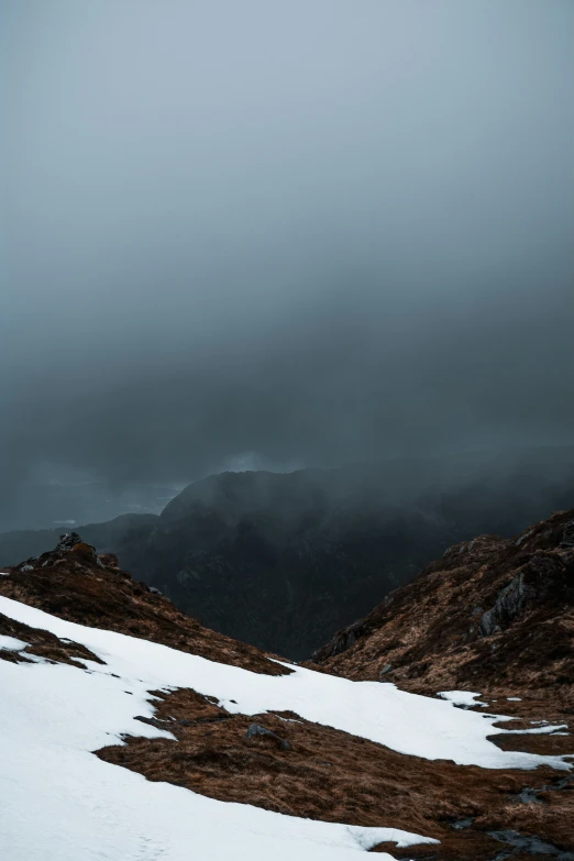 a couple of hills covered in snow and grass