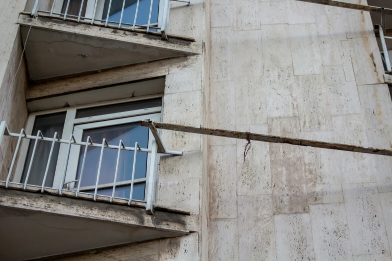 an apartment building with balconies and metal railings