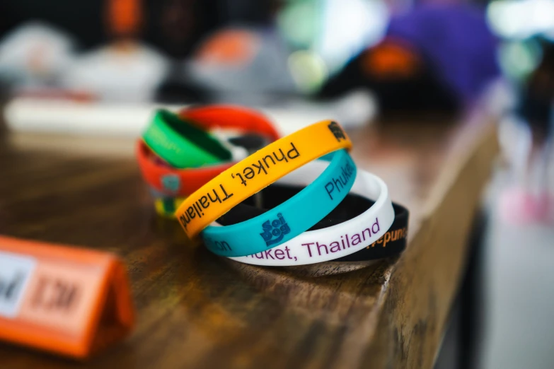 four celets that say friend, proud thai and thailand on them