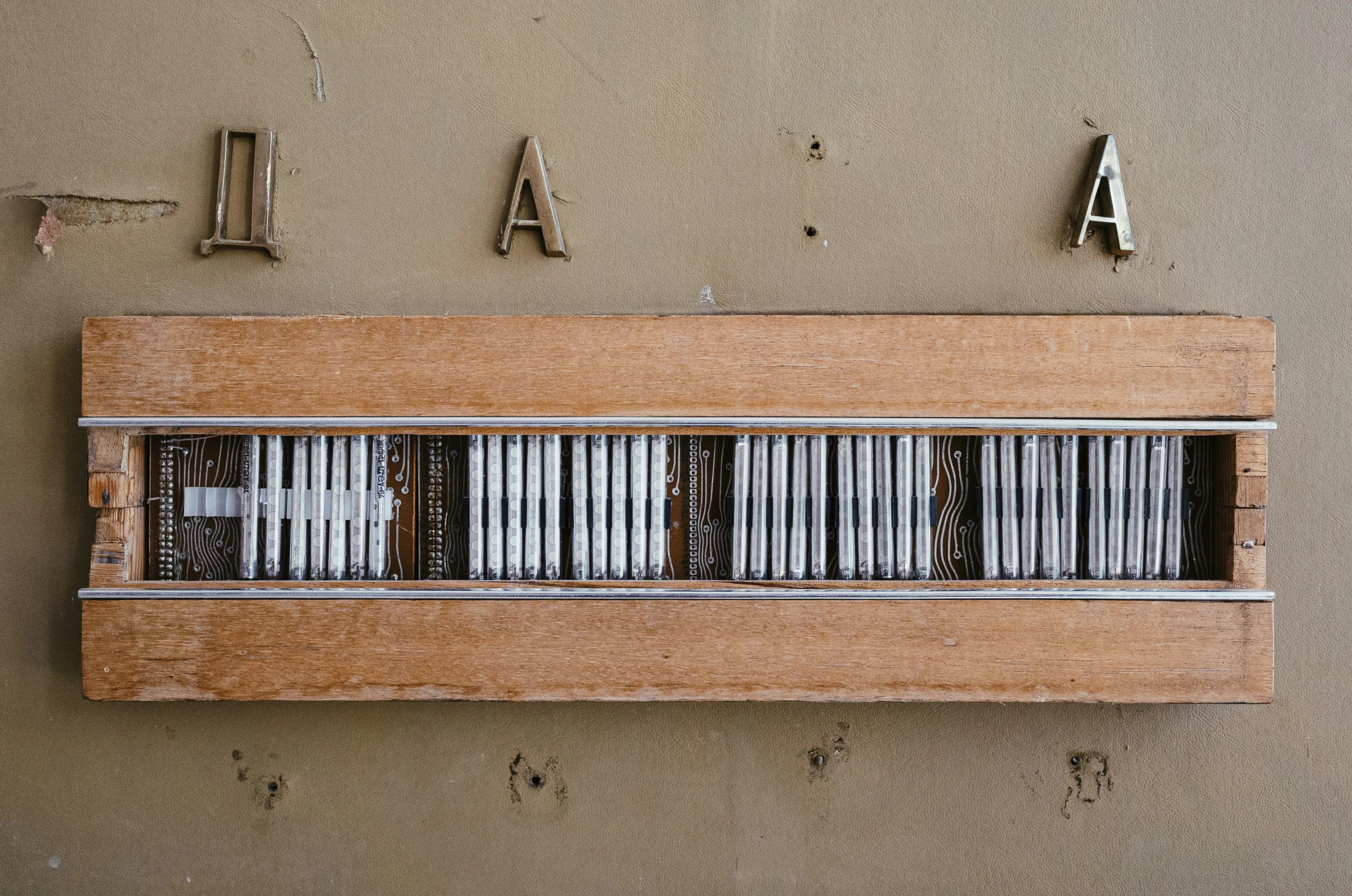 a wooden typewriter is on the wall for display