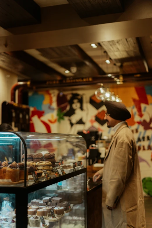 a man that is behind the counter with a glass case