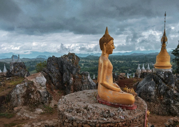 the buddha statue is located in a natural landscape area