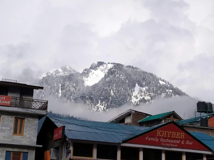 some buildings that are near some mountains