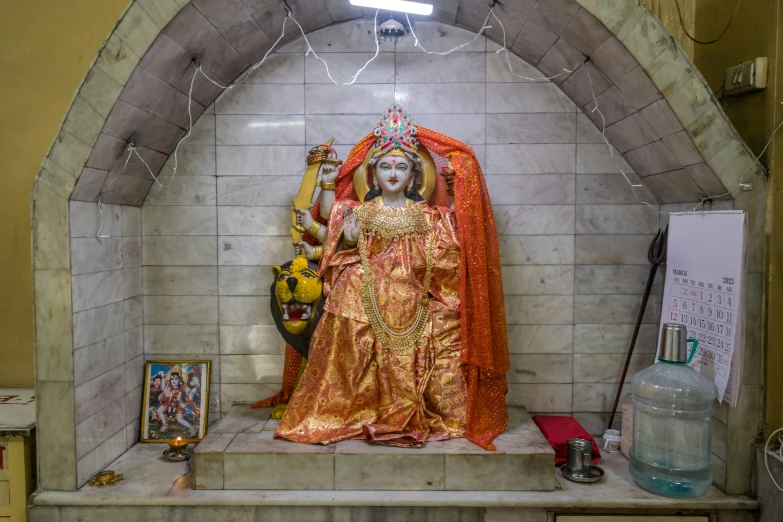 a statue of a woman dressed in a gold robe