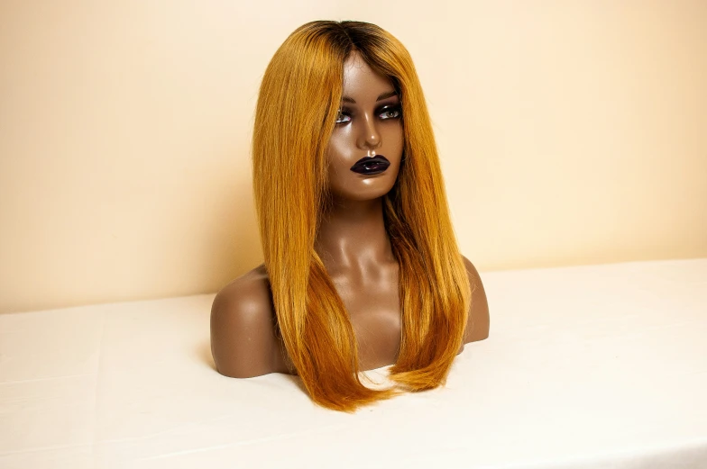 a woman's head with bright orange hair in an undgeid wig