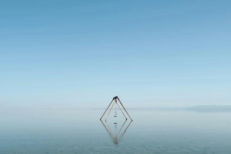 a single white structure floating on a large body of water