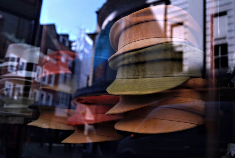 hats on display in a window of a business